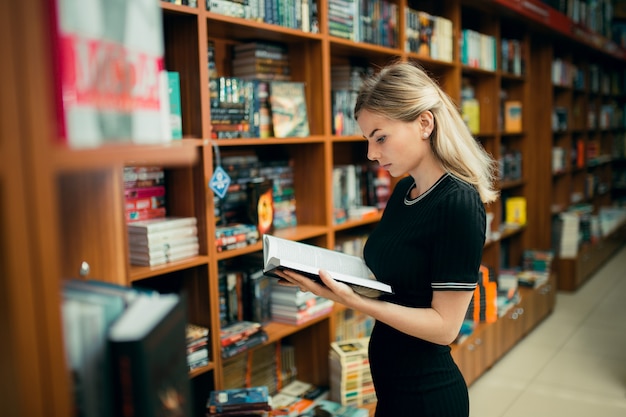 Student reading a book in the library