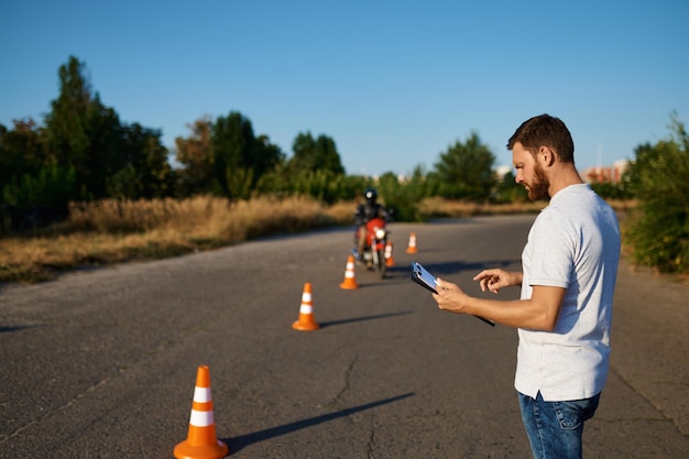 Student rides around the cones, motorcycle school. Training of motorcyclists beginners, biker practicing in motorschool