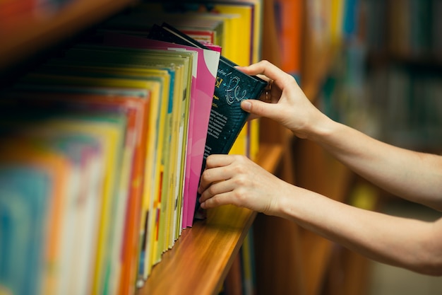 Student searching for books in a library