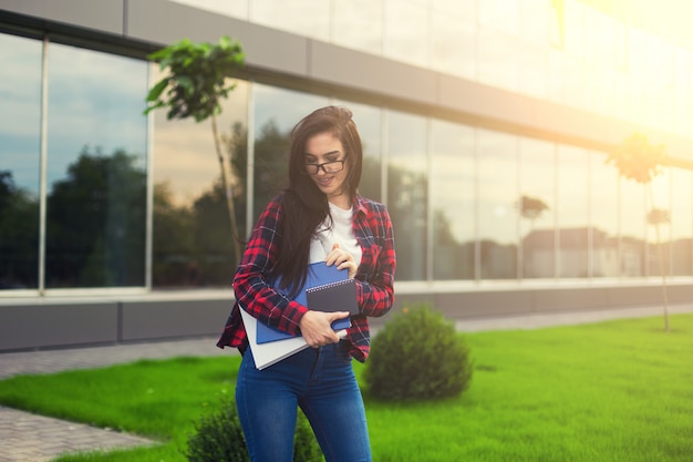 Student Teen Girl in Casual Outfit Holding Books and Smiling at the Camera While Standing