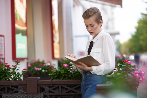 Student with a book in his hands outdoors rest fun walking around town Lifestyle