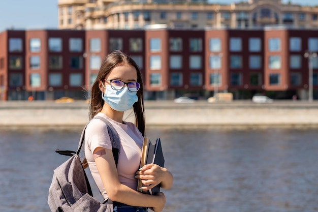 Student with medical plaster on hand back to school in the fall after vaccination the beginning of the new school year during covid19 teenagers receive the vaccine