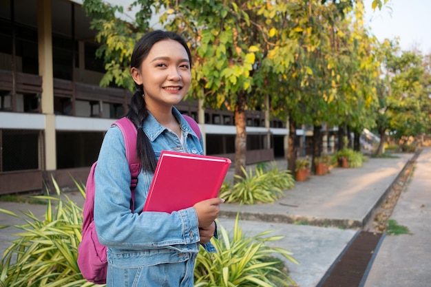 Student young girl with pink book standing at schoo