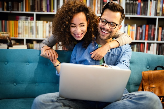 Students are studying together in library. Couple, study, technology, education love concept