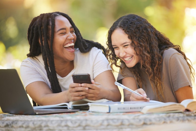 Students friends and women with phone at park laughing at funny meme University scholarship comic and happy girls or females with mobile smartphone laugh at joke or crazy comedy on social media