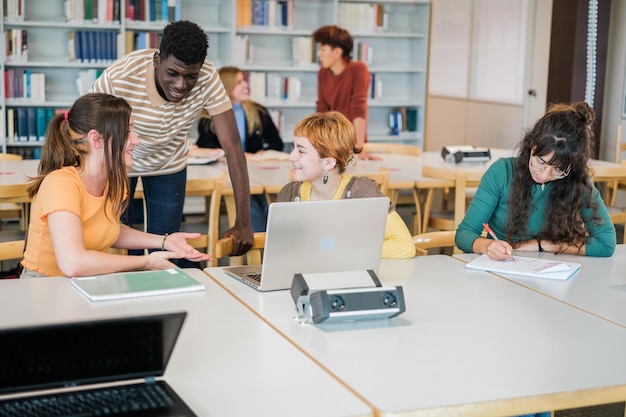 Students gathered in a group to do work together in the university library