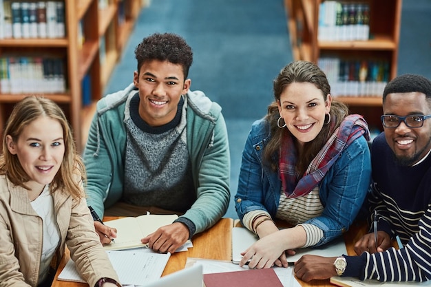 Students group and portrait with books for education research and happy for learning at college Man girl and friends with reading for collaboration support or diversity for knowledge at campus