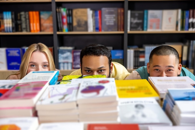 Students hiding behind the bookshelves