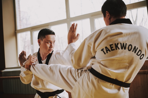 Students practice martial arts in the gym.