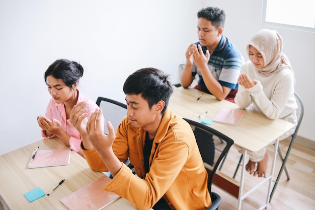 Students Praying Together Before Studying in The Class