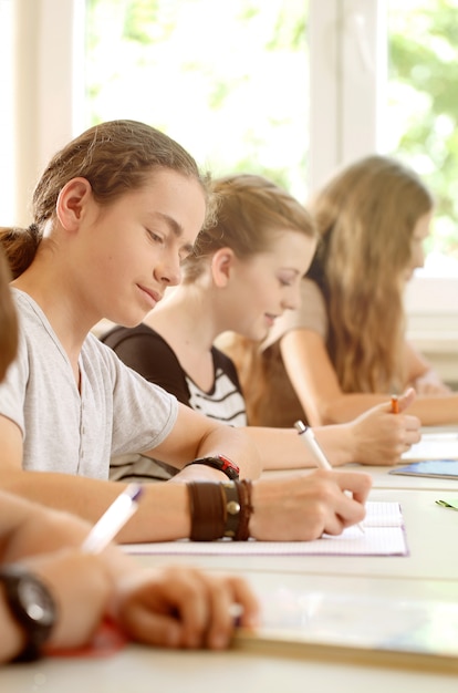 Students or pupils writing test in school being concentrated