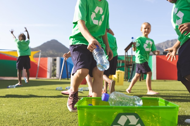 Students putting plastic bottles on dustbin