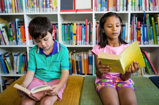 Students reading books in school library