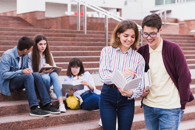 Students standing together with open notebook