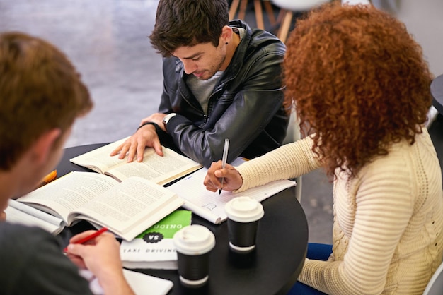 Students studying in a group in library people learning for university education and scholarship Academic development knowledge with young men and woman study for exam research and writing notes