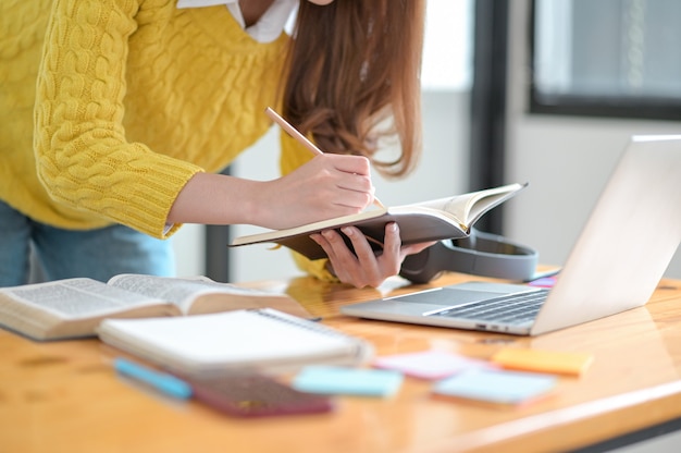 Students use laptops and take notes for university entrance exams.