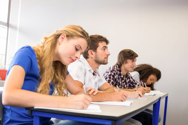 Students writing notes in classroom