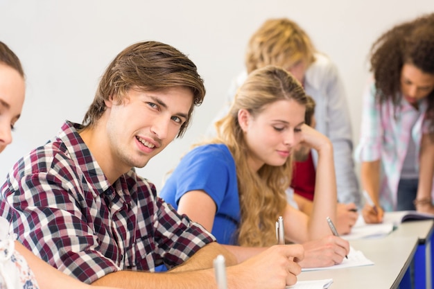 Students writing notes in classroom