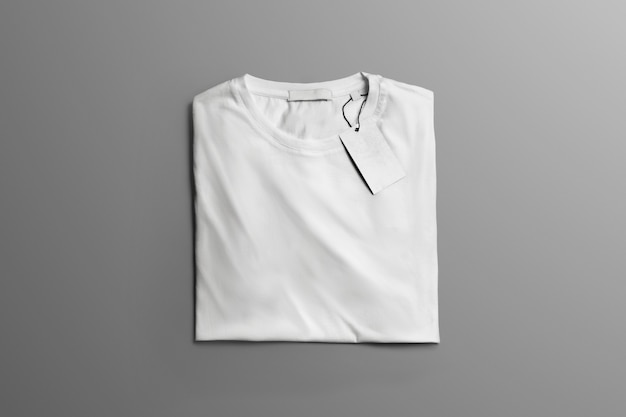 Studio mockup  of clothes. Neatly folded blank T-shirt  lies on the gray background  with shadows. Template can use for you showcase.