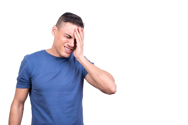 Photo studio photo of a man with headache touching his hand to his head in a white background