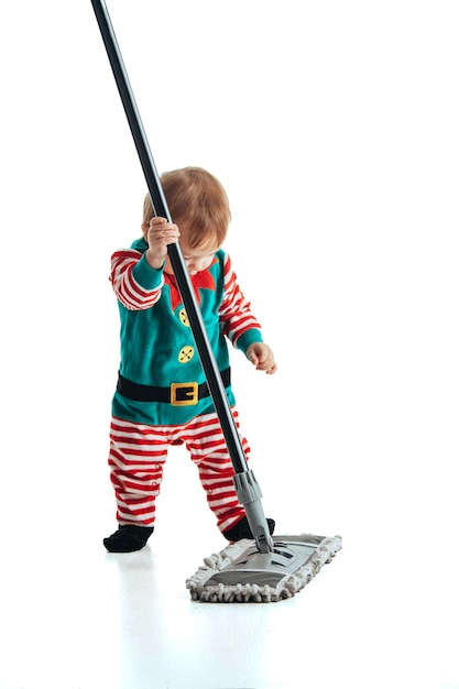 Studio photo with white background of a baby disguised as a elf playing