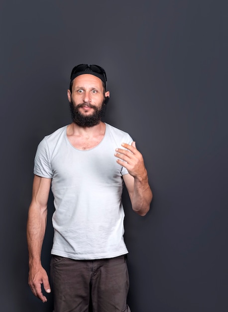 Studio portrait of american handsome bearded man Surprised with bulging eyes. Positive emotions concept. Humorous photo of Russian Man smiling to camera, having pleased expression and cheerful look