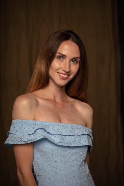 studio portrait on a dark background of a beautiful young woman