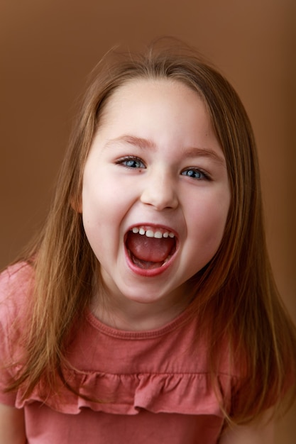 Studio portrait of funny smiling preschool girl