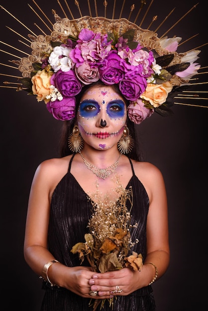 Studio portrait of a girl with catrina makeup looking at camera