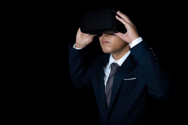 Studio portrait man wearing VR Headset on black background Glasses of virtual reality Technology metaverse gaming entertainment and people concept copy space