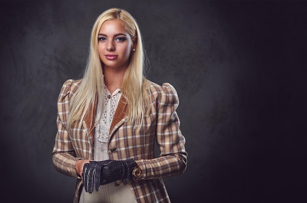 Studio portrait of old fashioned blonde female on grey background.