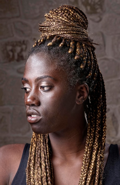 Studio portrait of a young black woman with braids