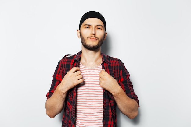 Studio portrait of young cool guy in red casual clothes on white background