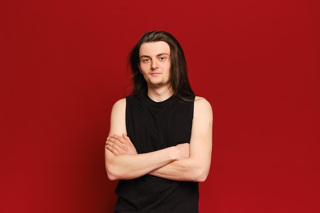 Studio portrait of young handsome man with long black hair