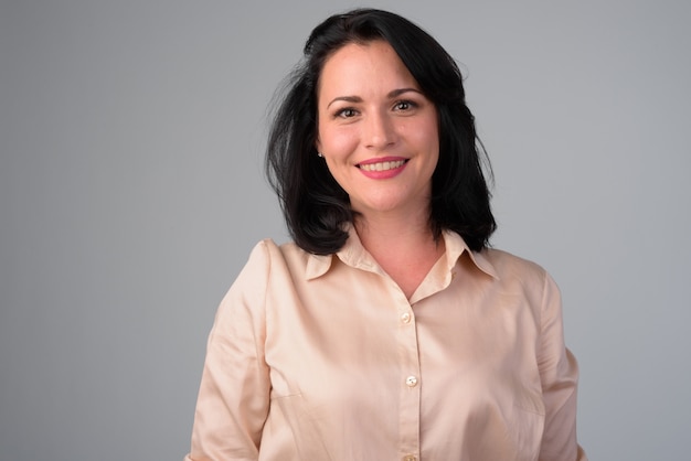 Studio shot of beautiful businesswoman against white