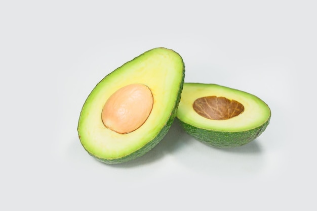 Studio shot of cut avocado on white background