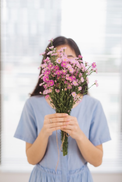 Studio shot of happiness woman receiving pretty flowers