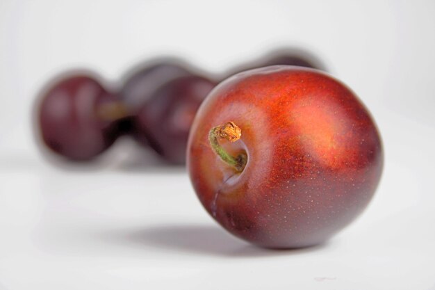 Photo studio shot of plums on white background