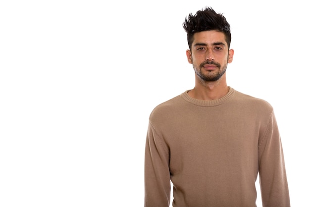 Studio shot of young bearded Persian man looking at camera