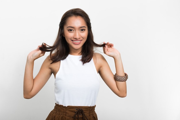 Studio shot of young beautiful Asian woman