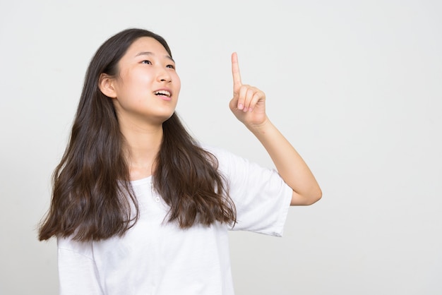 Studio shot of young beautiful Korean woman against white background