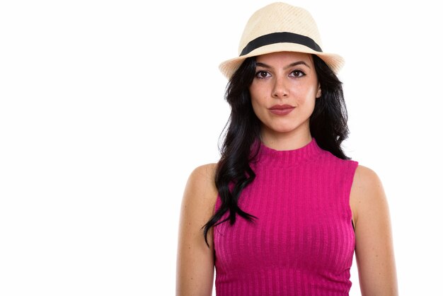 Studio shot of young beautiful Spanish woman wearing hat