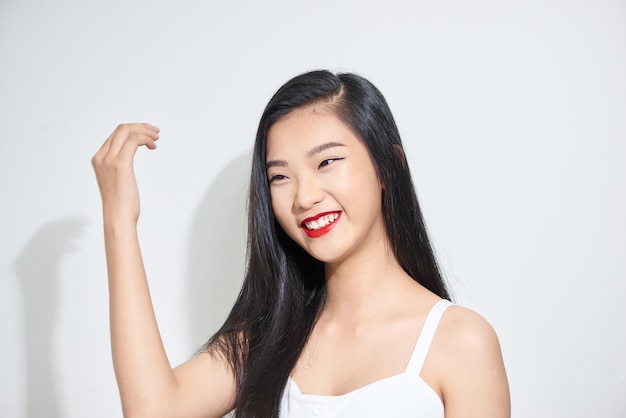 Studio shot of young charming dark haired woman with festive makeup looking thoughtfully aside