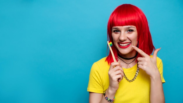 Studio shot of a young funny girl with a toothbrush in her hands The concept of oral care and brushing teeth A place for your text