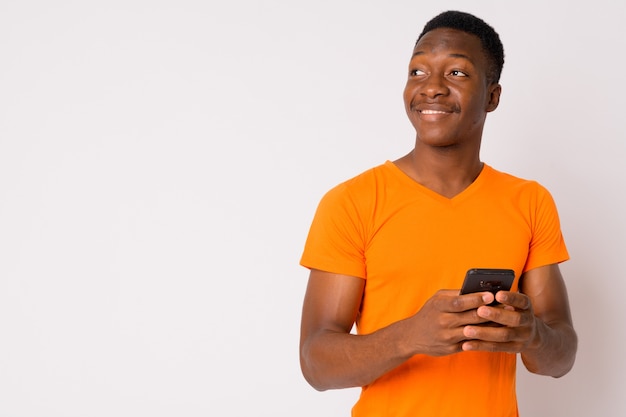 Studio shot of young handsome African man with Afro hair against white background