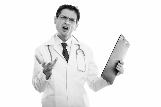 Studio shot of young skinny man doctor with eyeglasses isolated, black and white