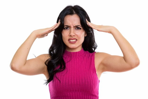 Studio shot of young stressed Spanish woman having headache