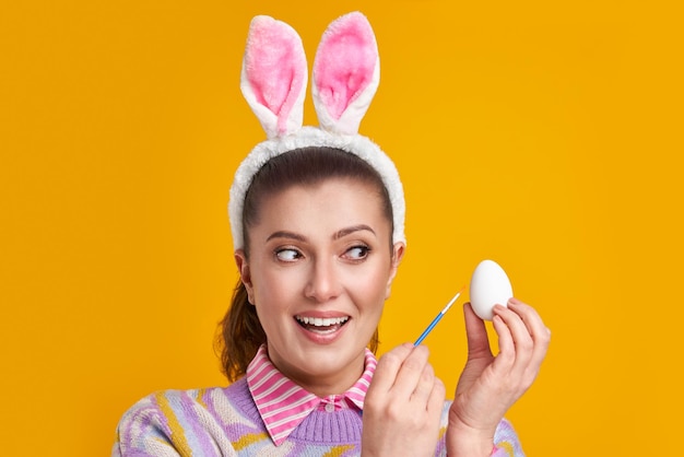 Studio shots of woman over yellow background Easter style High quality photo