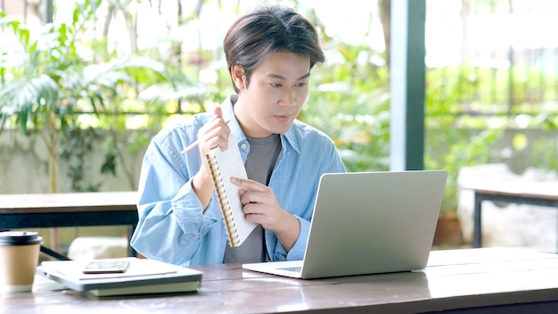 Study online class, Student man holding lecture while online learning with laptop computer,  Education and technology