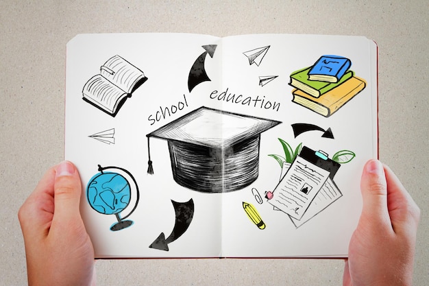 Studying in college education and knowledge concept with hand drawn mortarboard hat books globe and arrows on white notebook sheets holding by human hands